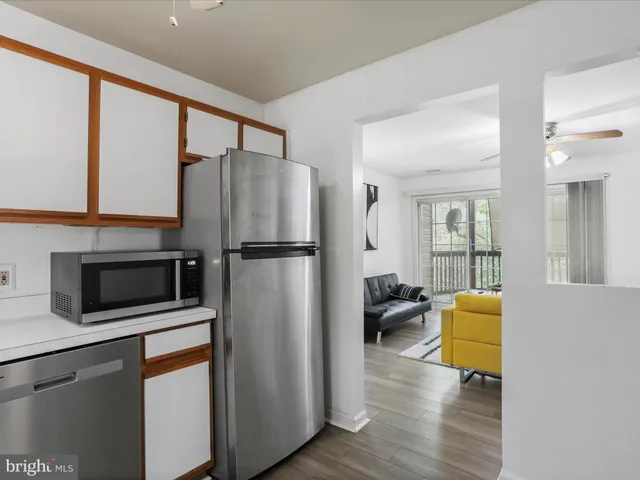a kitchen with a refrigerator and a stove top oven