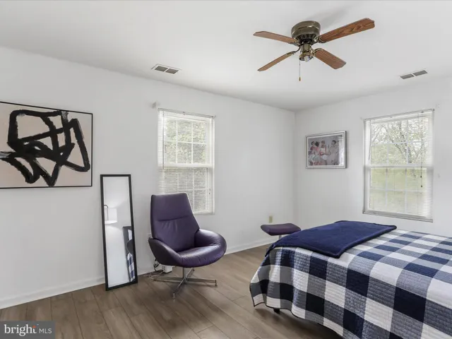 a bedroom with a bed and a chair