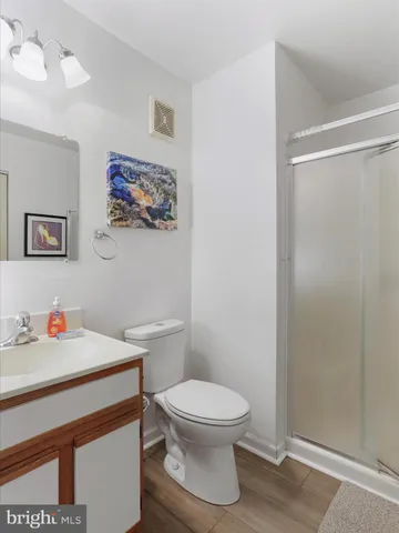 a white toilet sitting next to a bathroom sink