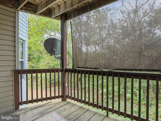 a view of a balcony with wooden floor
