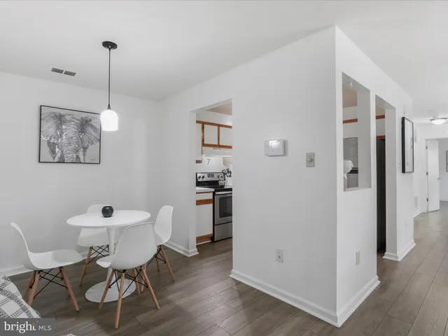 a dining room with furniture and wooden floor