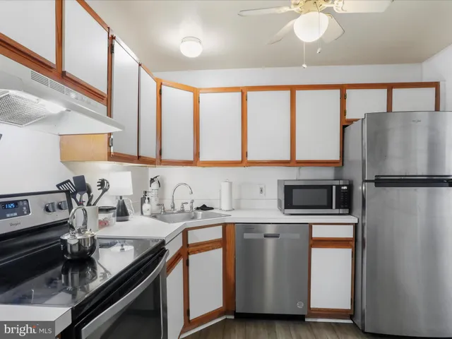 a kitchen with a sink appliances and cabinets