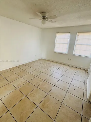 a view of an empty room and a window