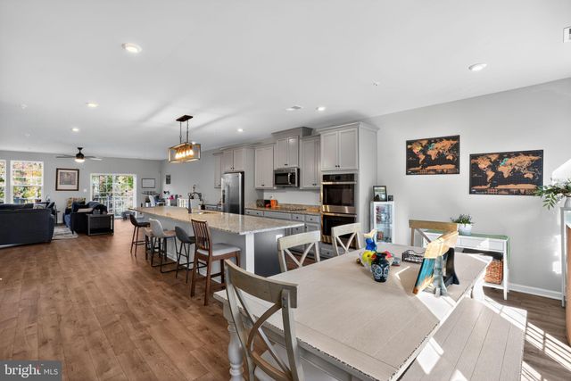 a living room with lots of furniture and kitchen view