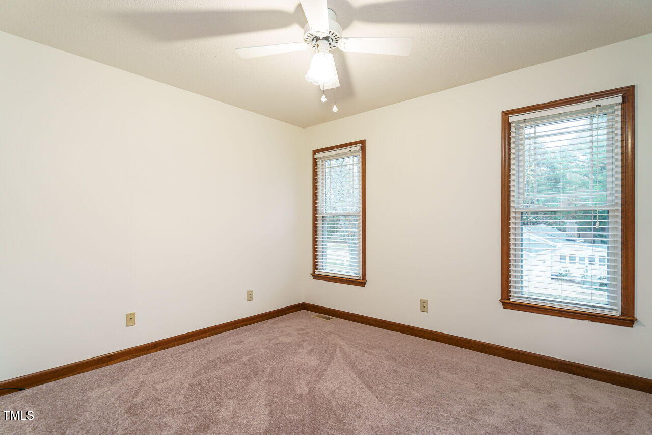 5917 Countryview Lane Raleigh, NC 27606 - Photo 17 of 43 Discover two charming secondary bedrooms, each thoughtfully updated with new carpet and paint. These rooms are more than just spaces; they are blank canvases awaiting your personal touch and creativity.