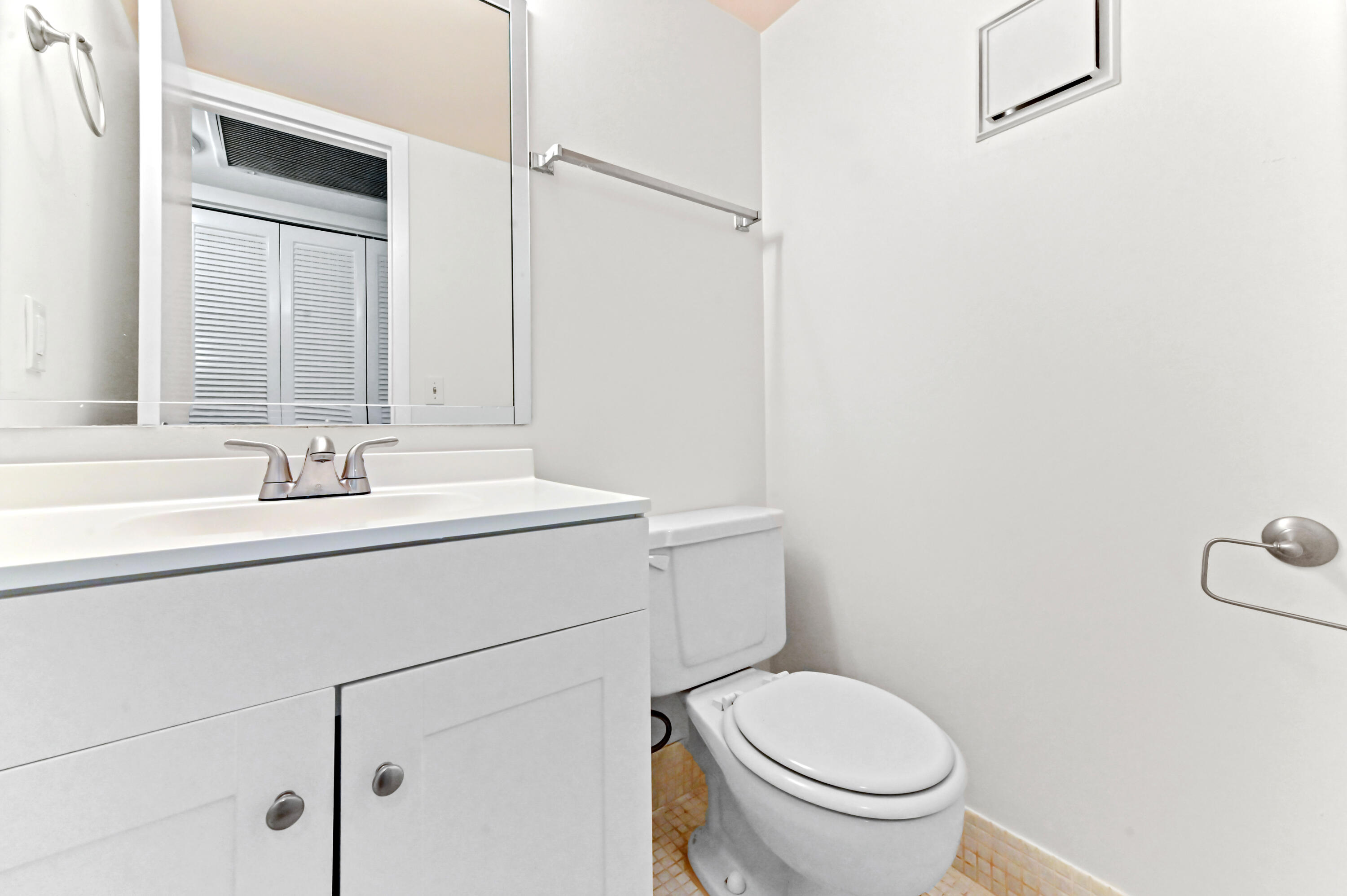 1010 Newcastle A, Unit 1010 Boca Raton, FL 33434 - Photo 13 of 27 a bathroom with a sink toilet and a mirror