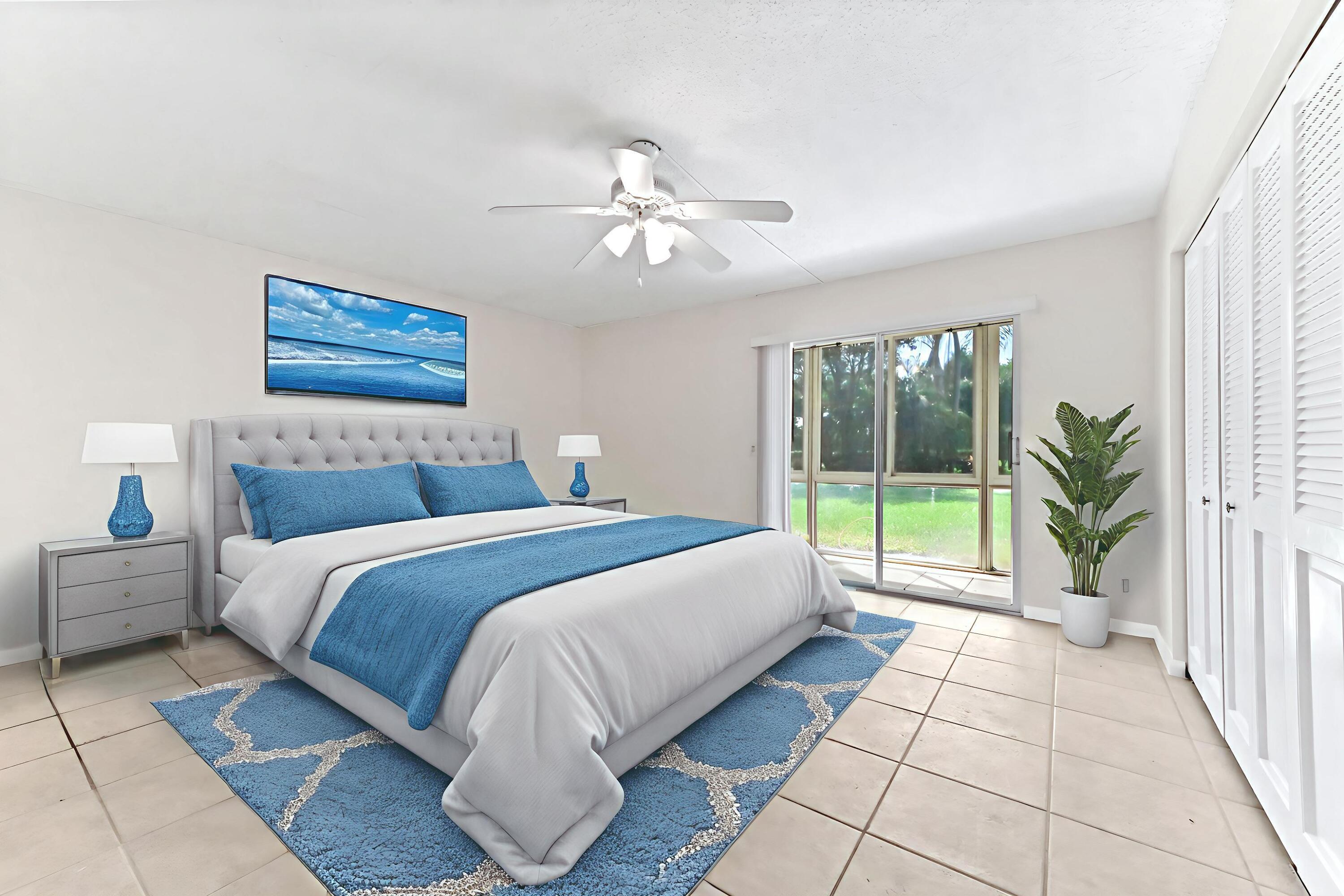 1010 Newcastle A, Unit 1010 Boca Raton, FL 33434 - Photo 14 of 27 a bed room with a bed and a large window
