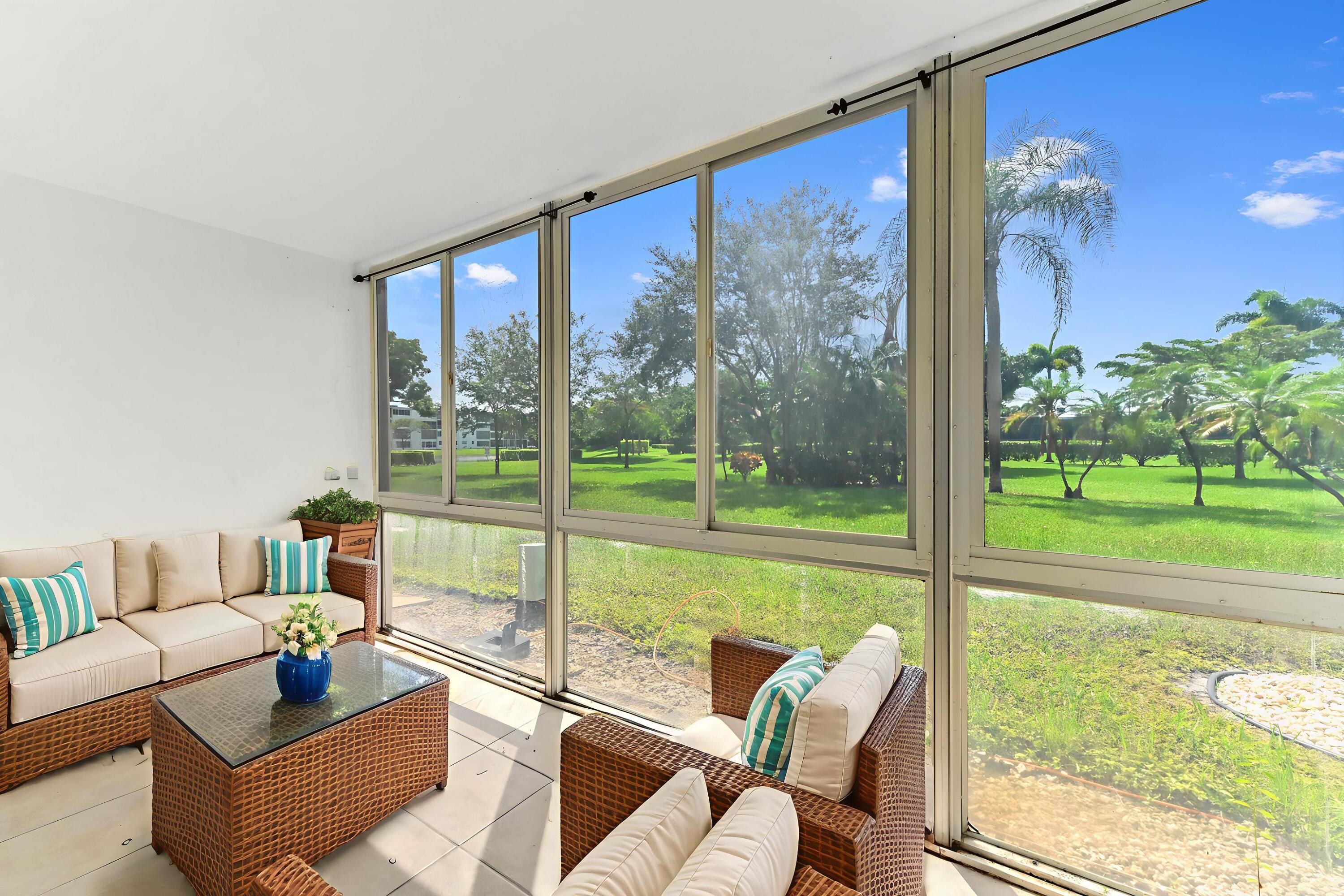 1010 Newcastle A, Unit 1010 Boca Raton, FL 33434 - Photo 20 of 27 a living room with furniture and a large window