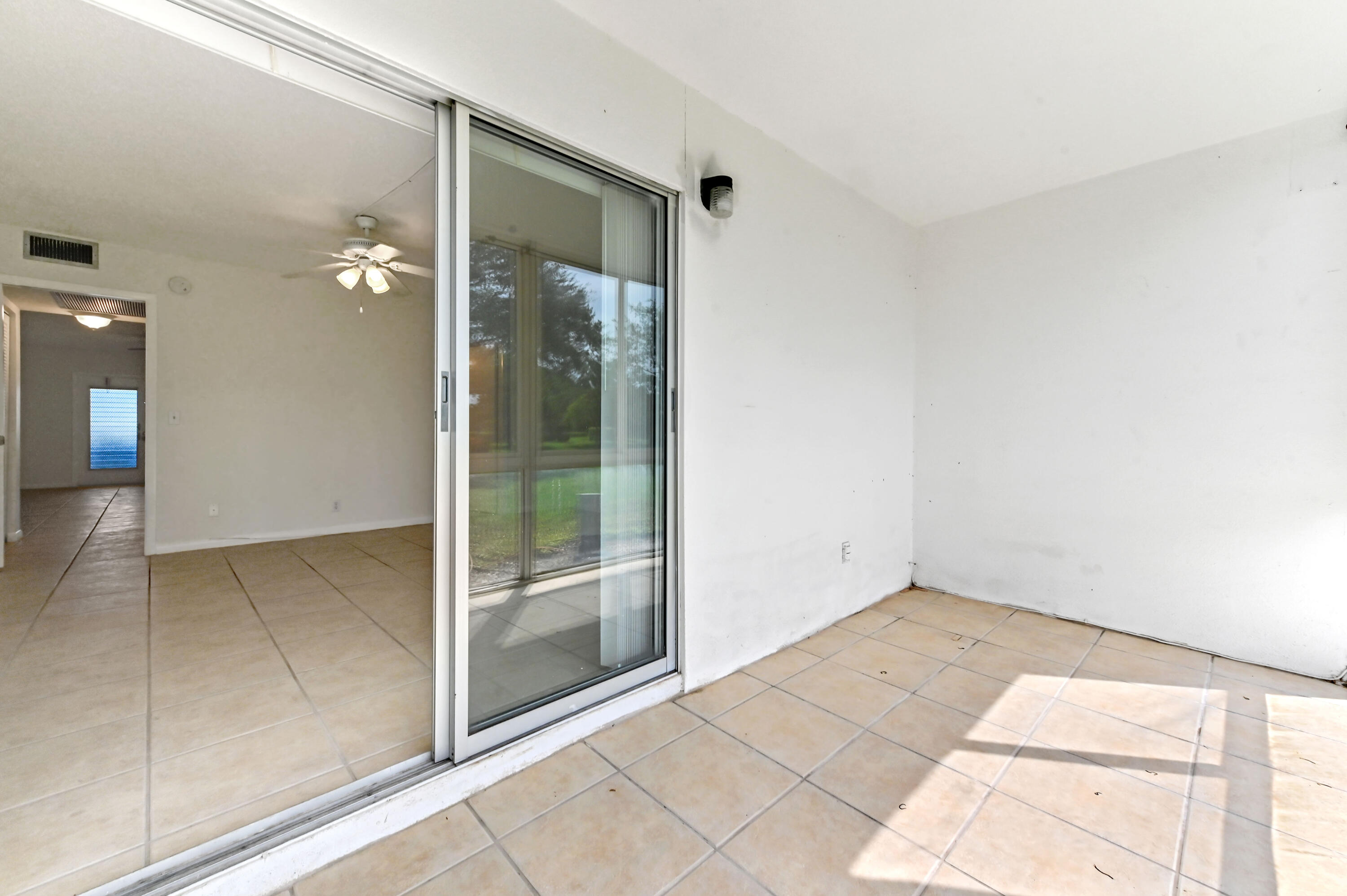 1010 Newcastle A, Unit 1010 Boca Raton, FL 33434 - Photo 22 of 27 a view of an empty room and window