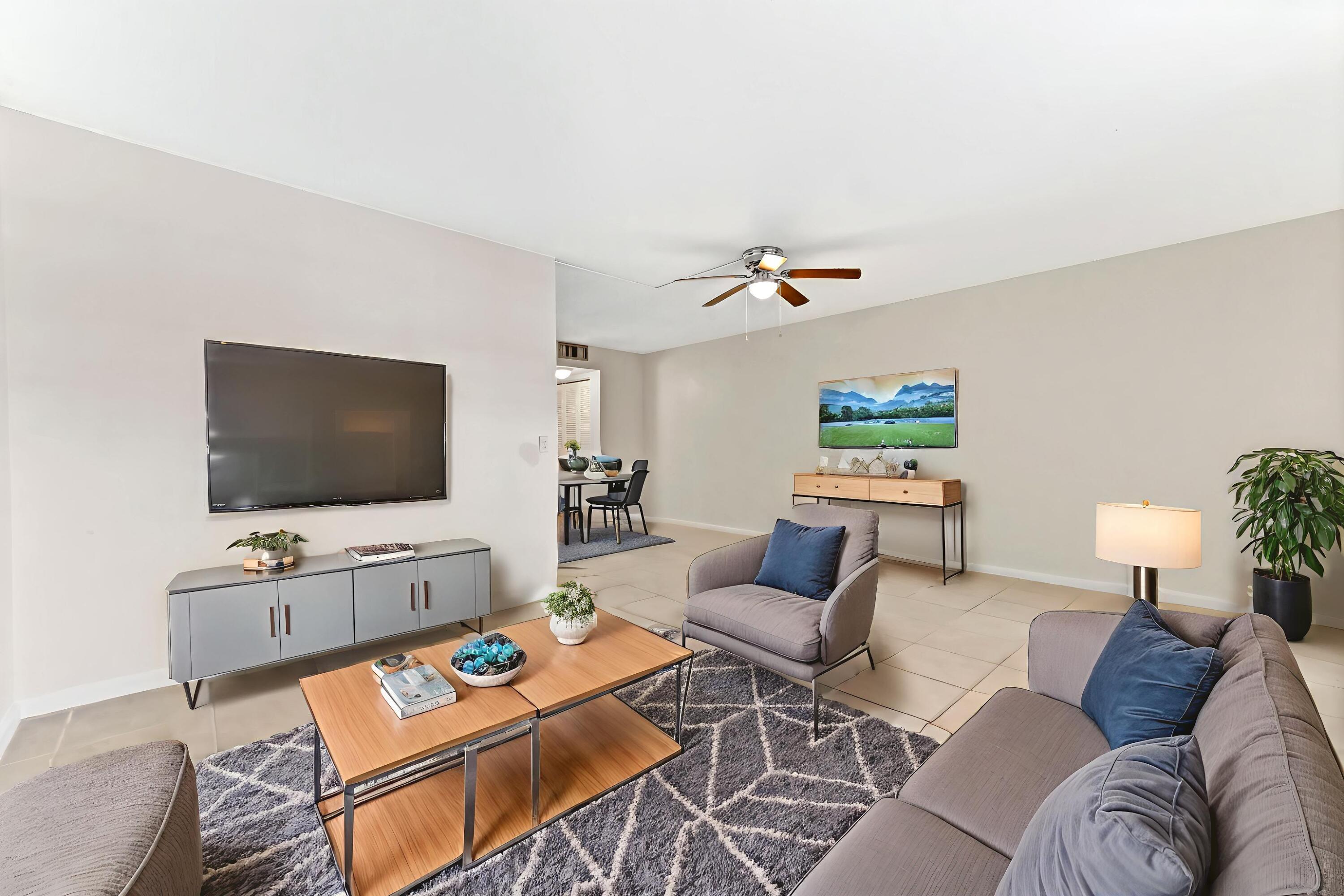 1010 Newcastle A, Unit 1010 Boca Raton, FL 33434 - Photo 7 of 27 a living room with furniture and a flat screen tv