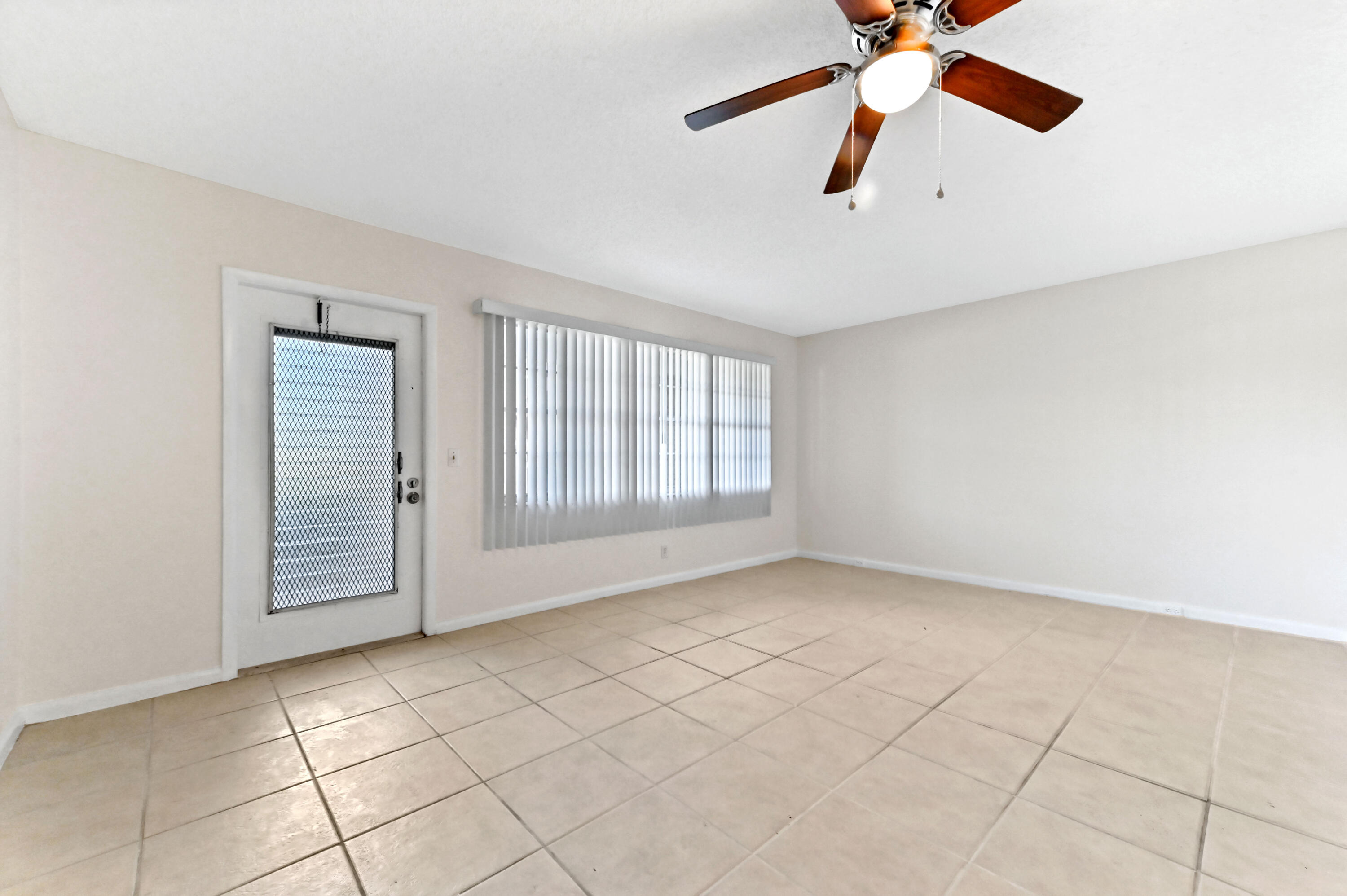 1010 Newcastle A, Unit 1010 Boca Raton, FL 33434 - Photo 9 of 27 an empty room with windows and fan