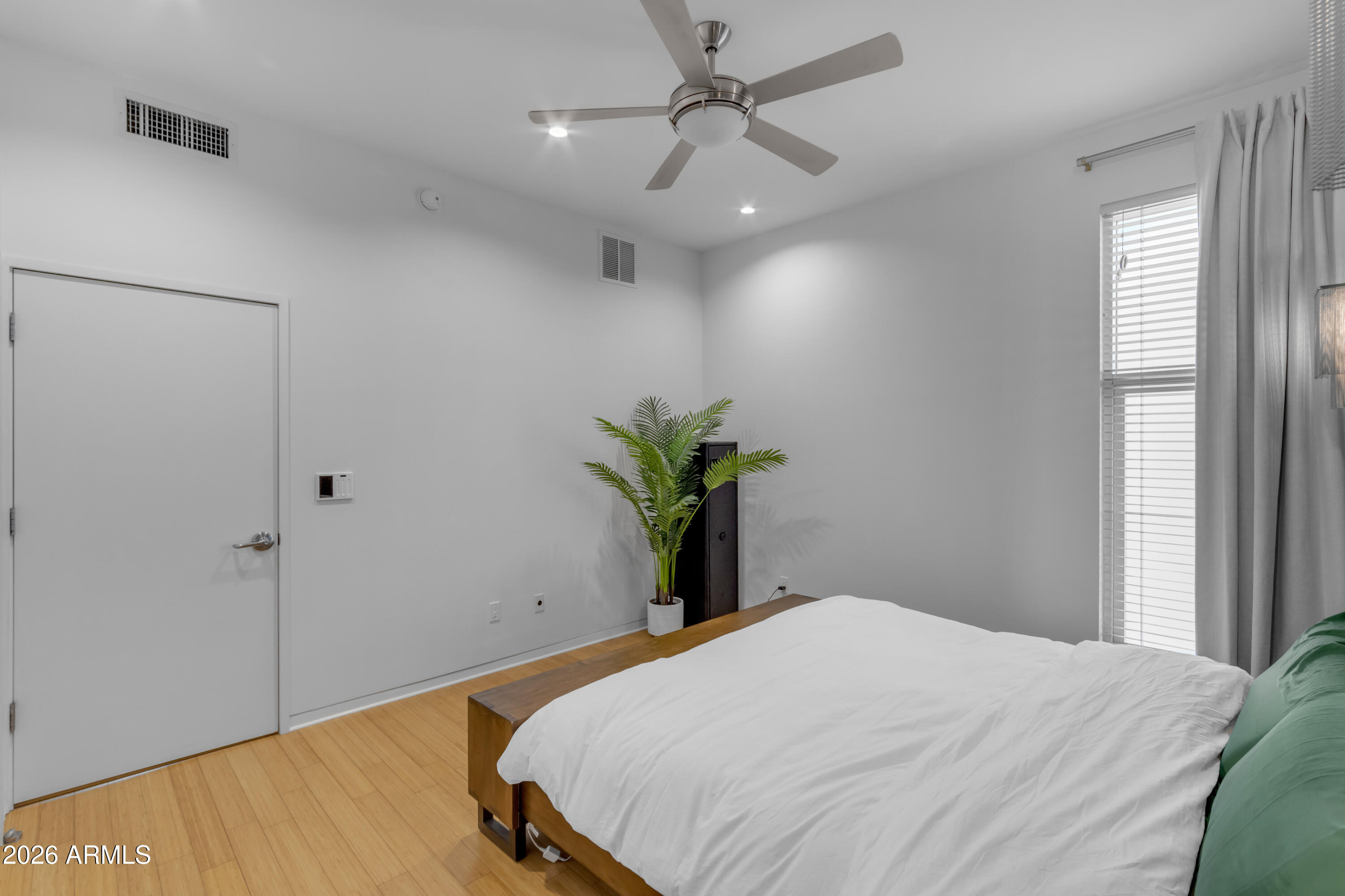 4410 North 27th Street, Unit 6 Phoenix, AZ 85016 - Photo 12 of 48 a bedroom with a bed and a potted plant