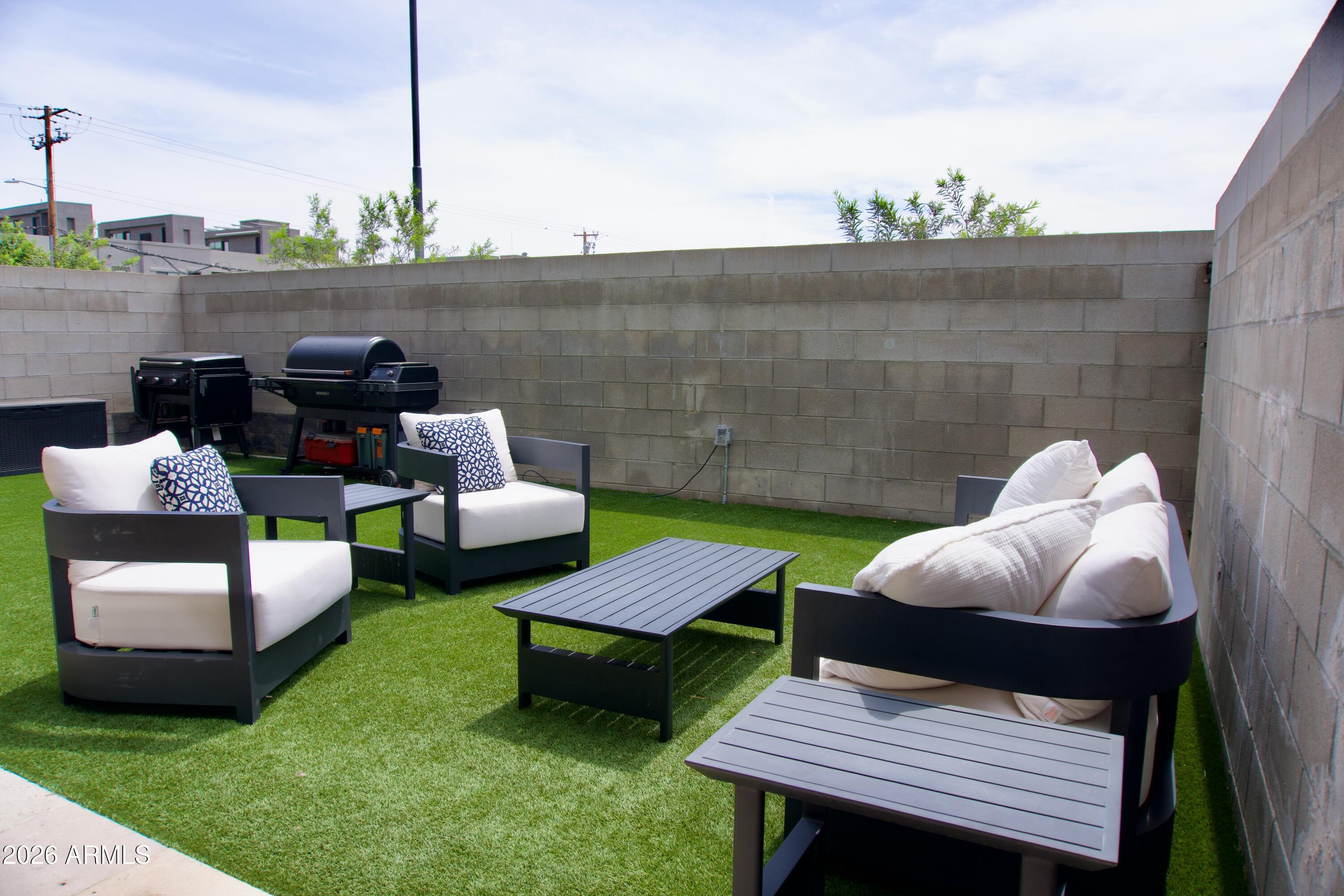4410 North 27th Street, Unit 6 Phoenix, AZ 85016 - Photo 35 of 48 a view of a patio with couches chairs and a fire pit