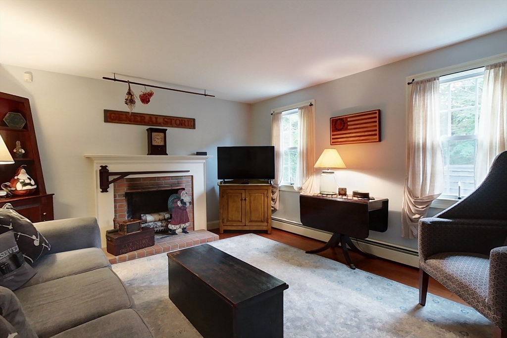 86 Turnpike Road Townsend, MA 01469 - Photo 14 of 42 a living room with furniture a flat screen tv and a fireplace