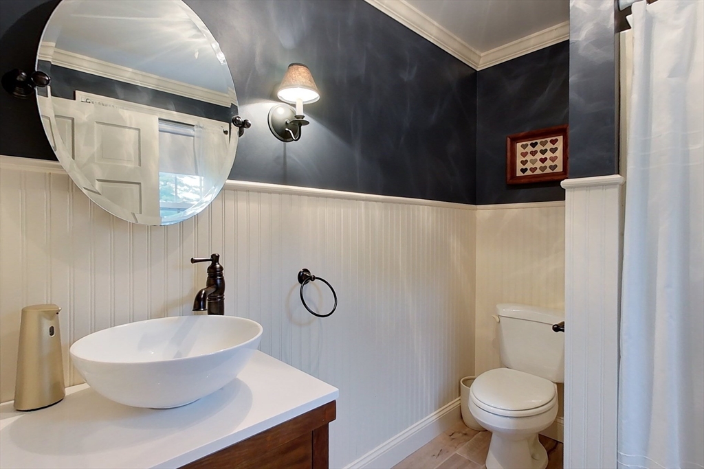 86 Turnpike Road Townsend, MA 01469 - Photo 22 of 42 a bathroom with a toilet a sink and mirror