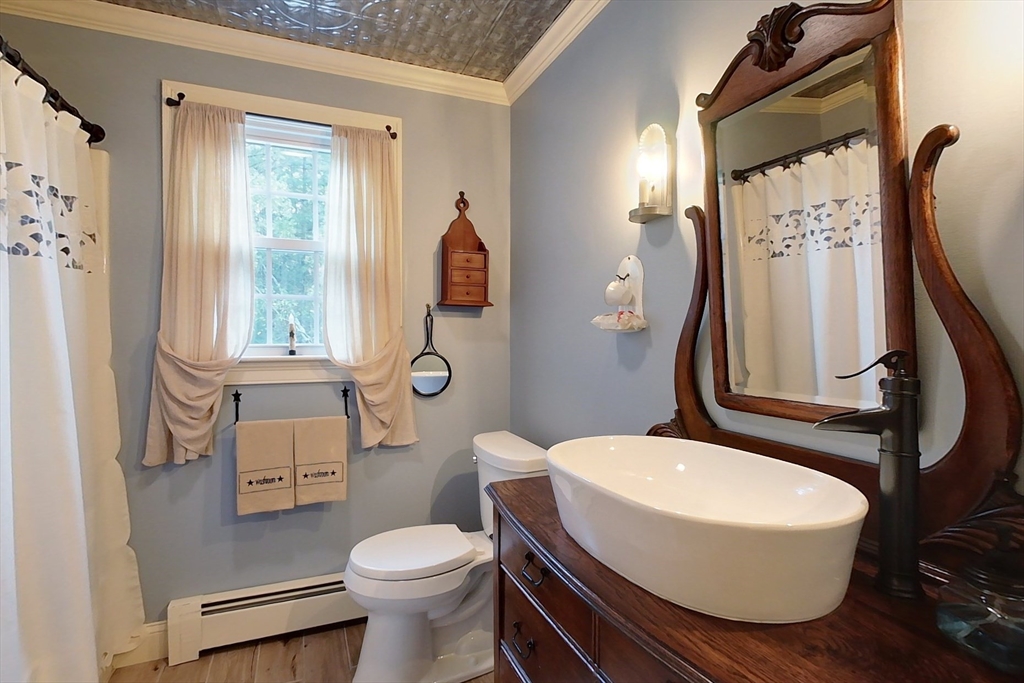 86 Turnpike Road Townsend, MA 01469 - Photo 29 of 42 a white toilet sitting next to a bathroom sink and a mirror