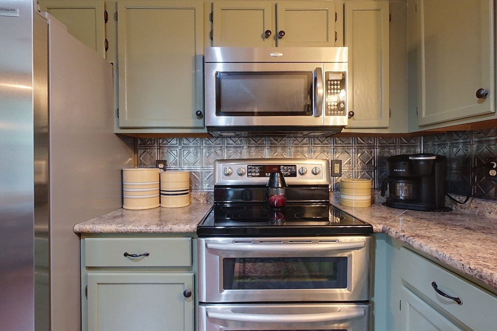 86 Turnpike Road Townsend, MA 01469 - Photo 5 of 42 a kitchen with granite countertop a stove and a microwave