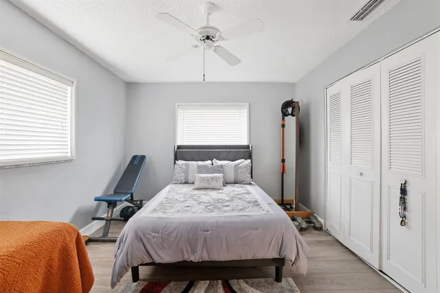 a bed room with a bed and a chair