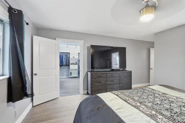 a bedroom with a bed and a flat screen television