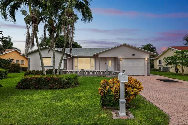 a front view of house with yard and outdoor seating