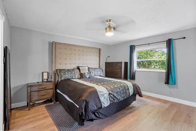 a bedroom with a bed lamps and window