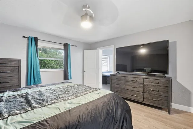 a bedroom with a bed and a flat screen tv