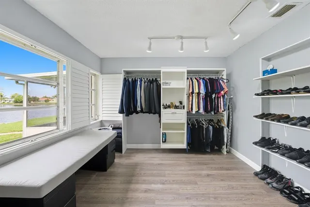 a hallway with a large window and kitchen view