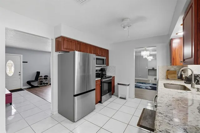 a kitchen with a refrigerator sink and stove