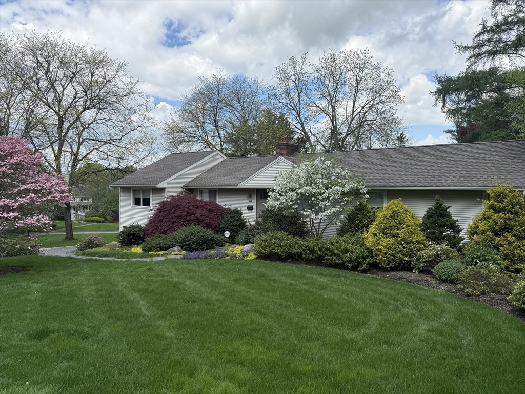 a front view of a house with a garden