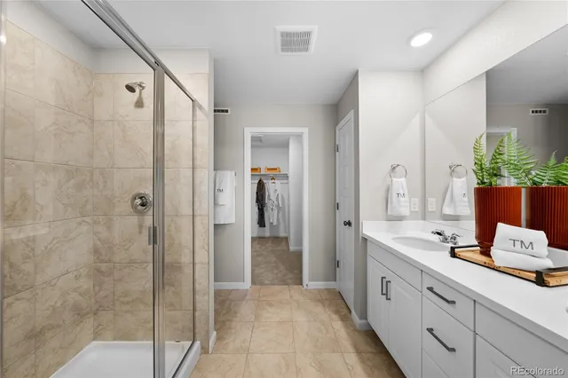 a view of walk in closet with clothes and shoes