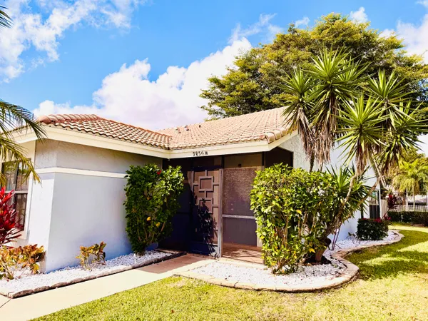 a view of a house with potted plants