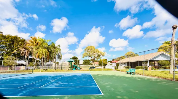 a view of yard with swimming pool and trees