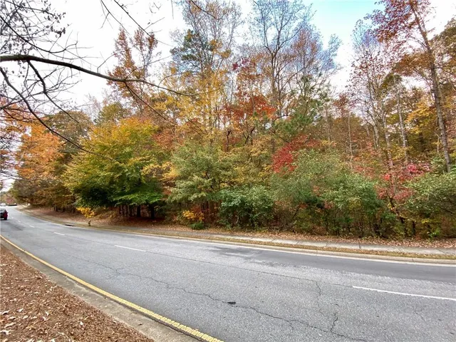a backyard of a house with large trees