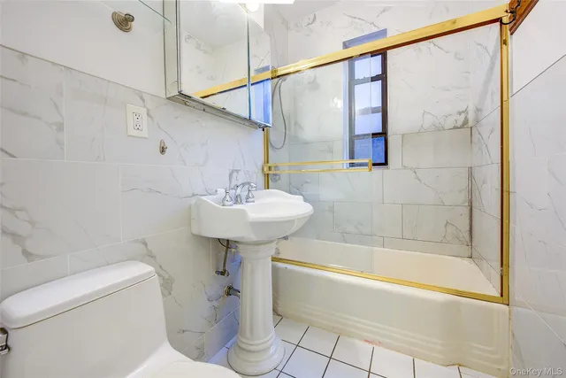 a bathroom with a sink a mirror toilet and bathtub