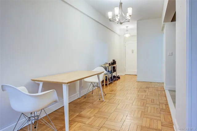 a view of a room with table and chairs