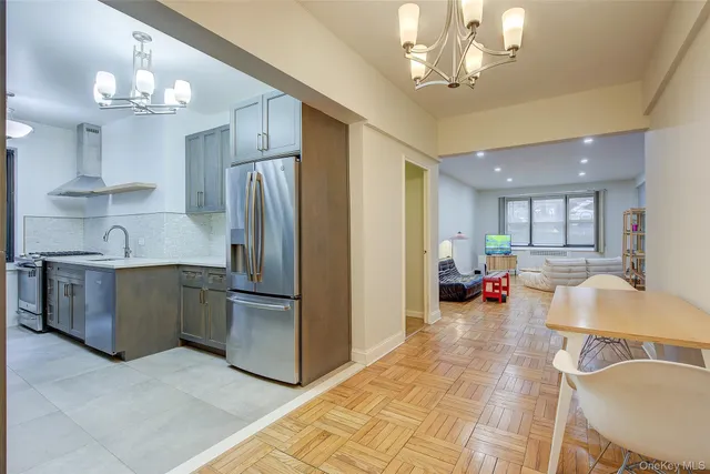 a kitchen with stainless steel appliances granite countertop a refrigerator and a sink