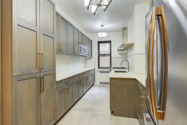 a kitchen with stainless steel appliances granite countertop a refrigerator and a sink