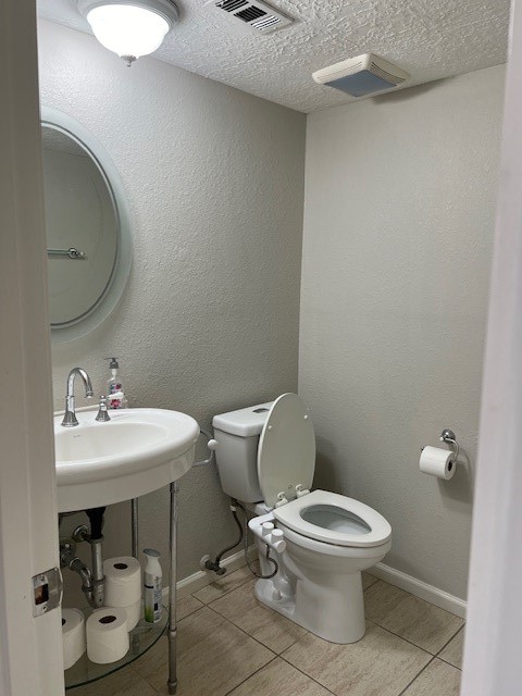 7407 Navidad Road Houston, TX 77083 - Photo 15 of 29 a white toilet sitting next to a bathroom sink