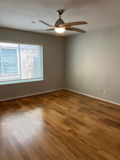 7407 Navidad Road Houston, TX 77083 - Photo 16 of 29 an empty room with wooden floor and windows