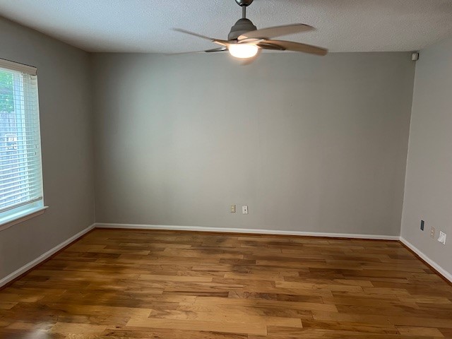 7407 Navidad Road Houston, TX 77083 - Photo 17 of 29 a view of room with window ceiling fan and hardwood floor