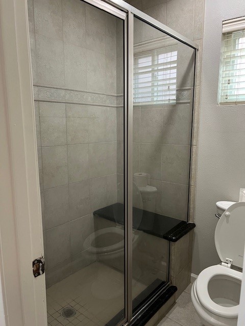 7407 Navidad Road Houston, TX 77083 - Photo 19 of 29 a bathroom with a toilet and a shower