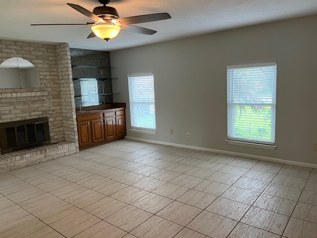 7407 Navidad Road Houston, TX 77083 - Photo 7 of 29 a view of an empty room with a fireplace and a window