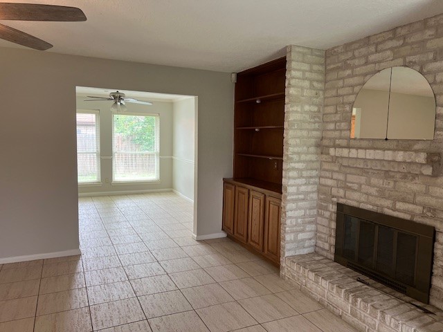 7407 Navidad Road Houston, TX 77083 - Photo 9 of 29 an empty room with windows and fireplace
