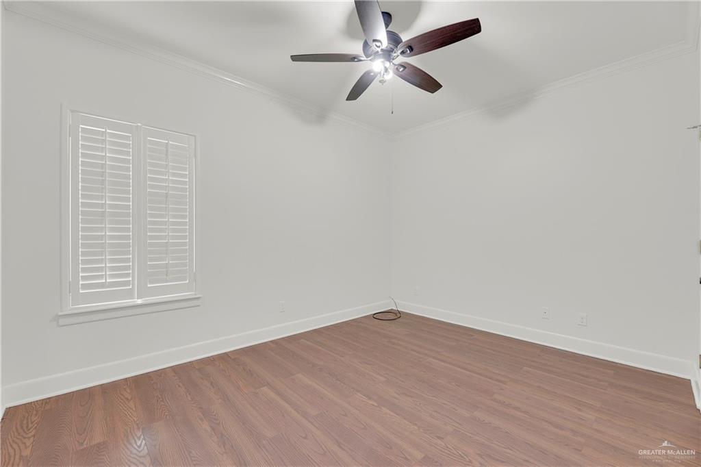 209 Robin Avenue McAllen, TX 78504 - Photo 15 of 20 an empty room with wooden floor fan and windows