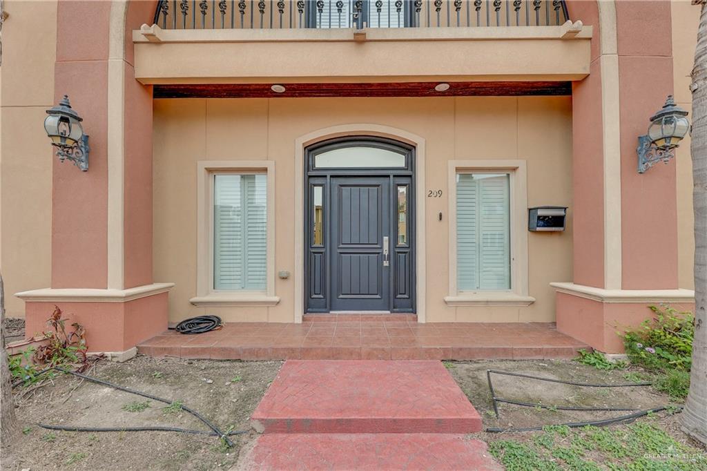 209 Robin Avenue McAllen, TX 78504 - Photo 2 of 20 a front view of a house with a glass door