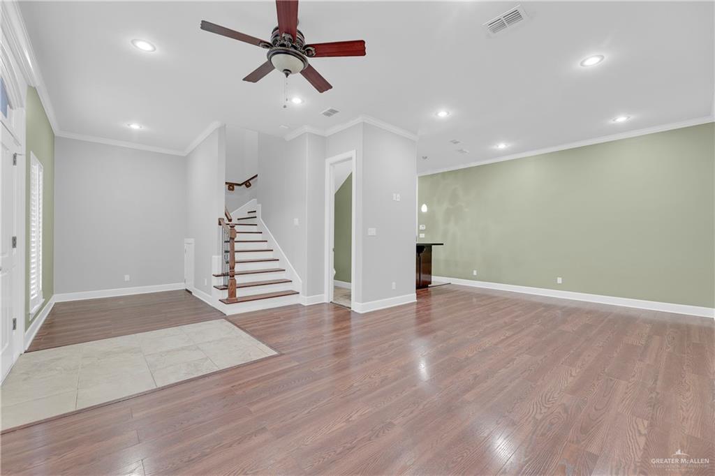 209 Robin Avenue McAllen, TX 78504 - Photo 3 of 20 a view of an empty room with wooden floor and stairs
