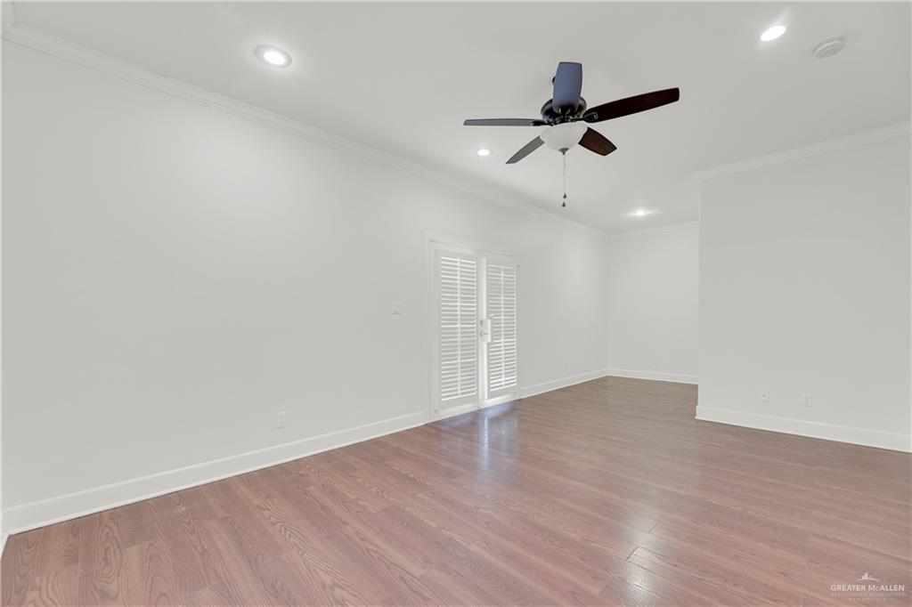 209 Robin Avenue McAllen, TX 78504 - Photo 10 of 20 an empty room with wooden floor ceiling fan and windows