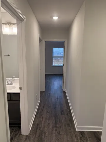 a view of a hallway with wooden floor