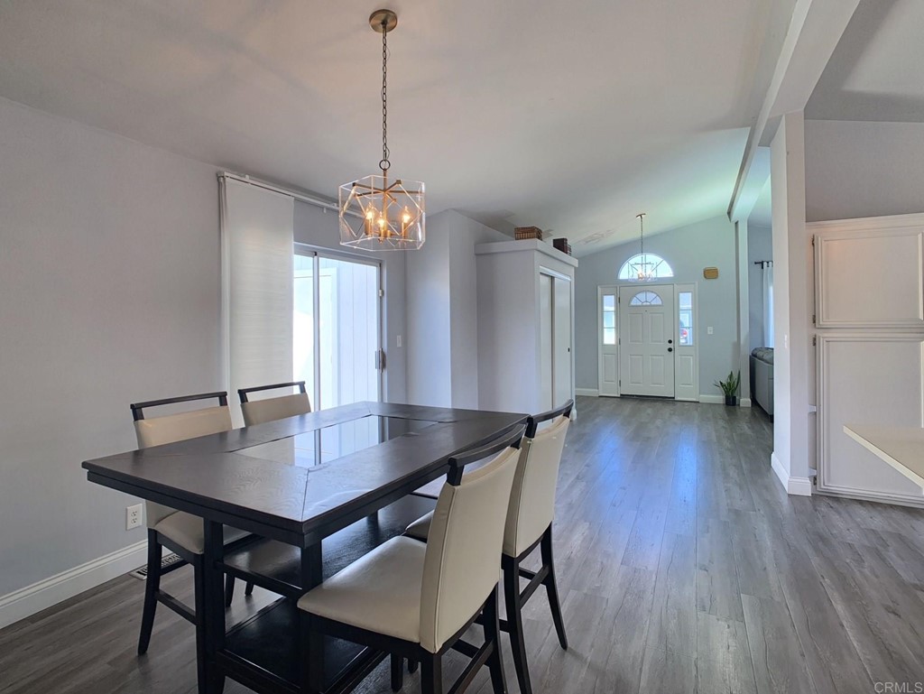 15935 Spring Oaks Road, Unit 63 El Cajon, CA 92021 - Photo 11 of 38 a view of a dining room with furniture wooden floor and a chandelier