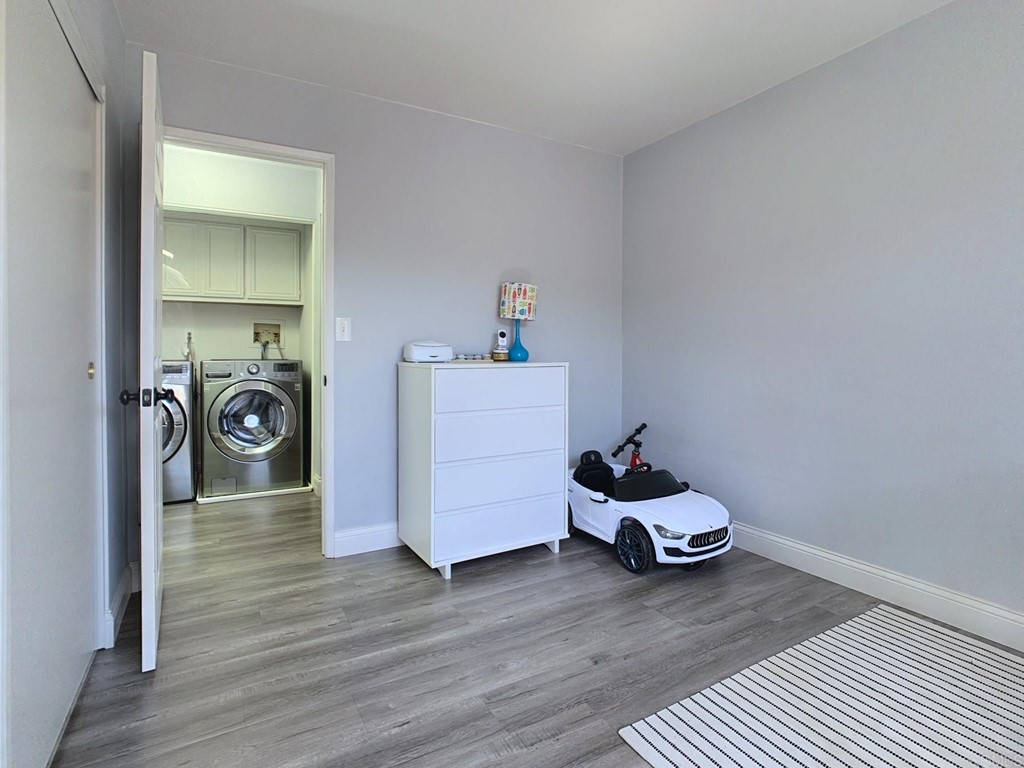 15935 Spring Oaks Road, Unit 63 El Cajon, CA 92021 - Photo 13 of 38 a room with a wooden floor washer and dryer